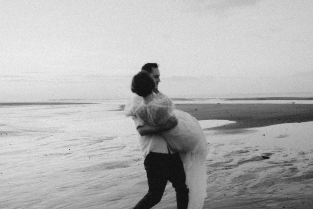 groom holding bride at their bali beach elopement