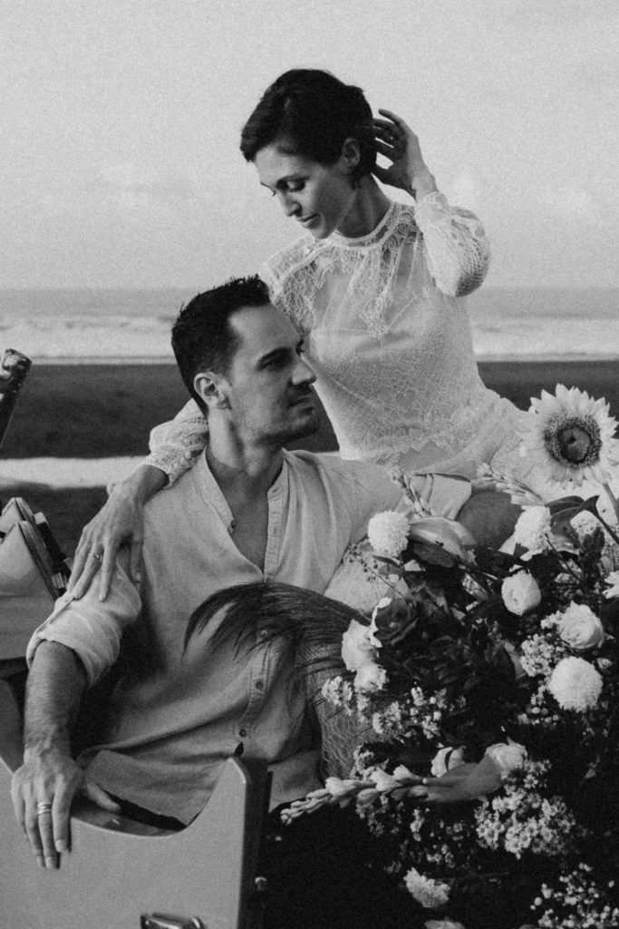 bride and groom looking off into the distance on the beach at their bali elopement