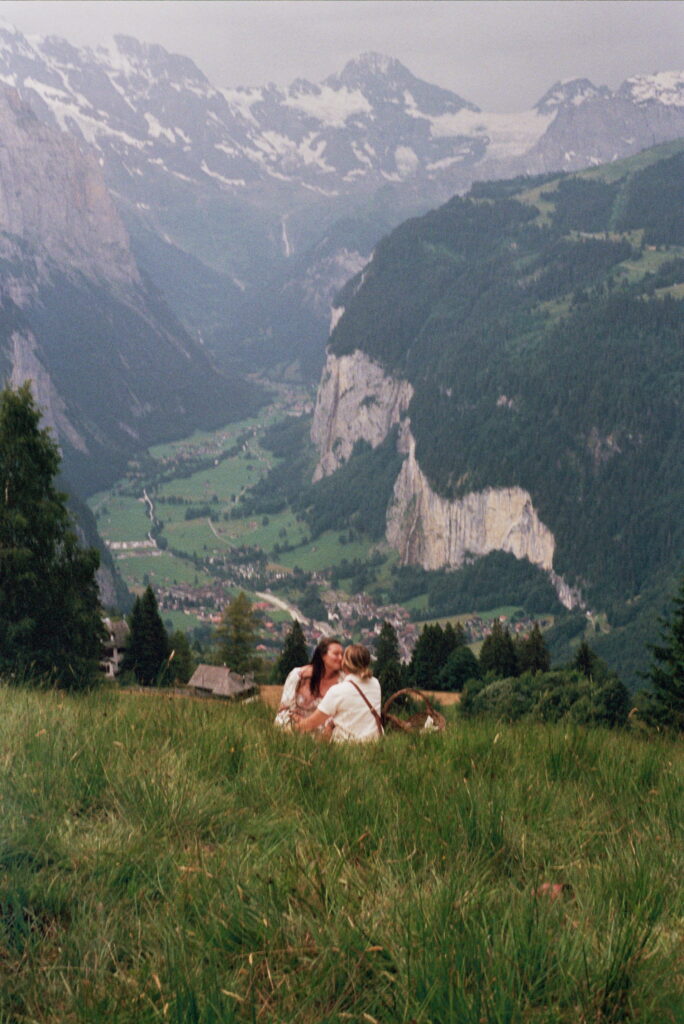 couple kissing with the swiss alps in the background at their switzerland elopement