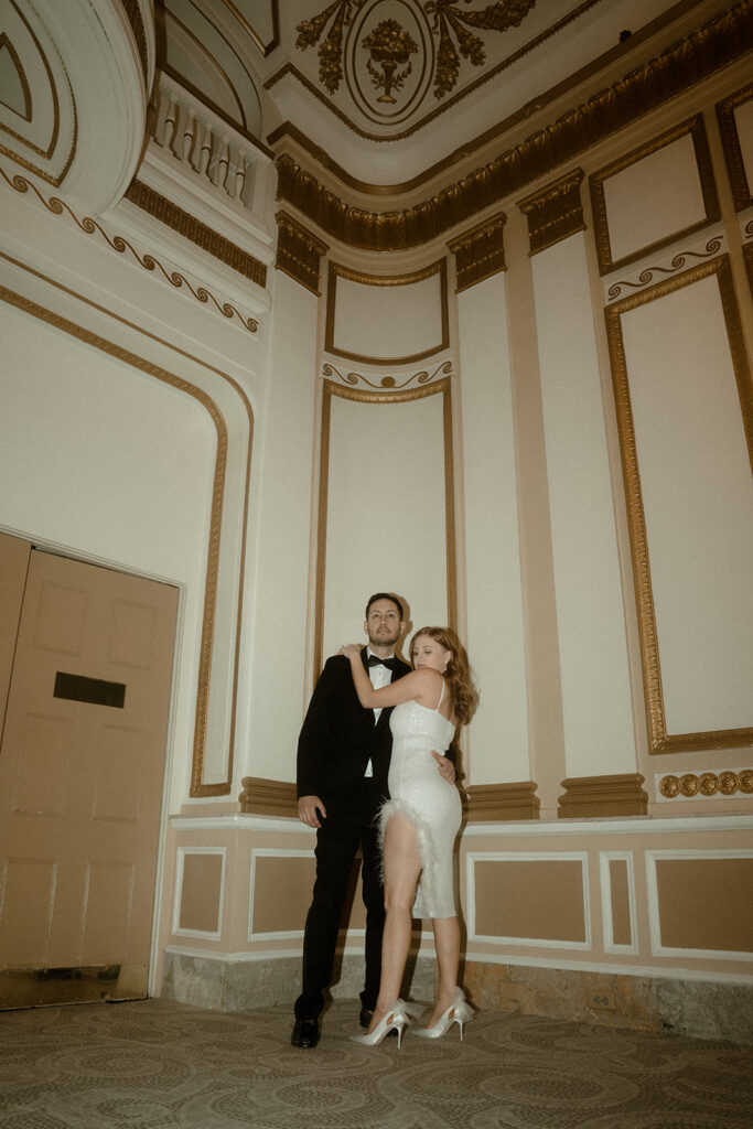 couple embracing in ballroom at the benson hotel during their portland engagement photos