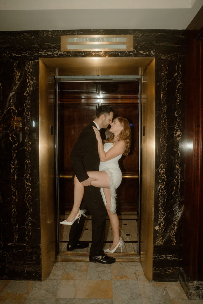 Couple kissing in The Benson Hotel elevator captured in Portland engagement photos
