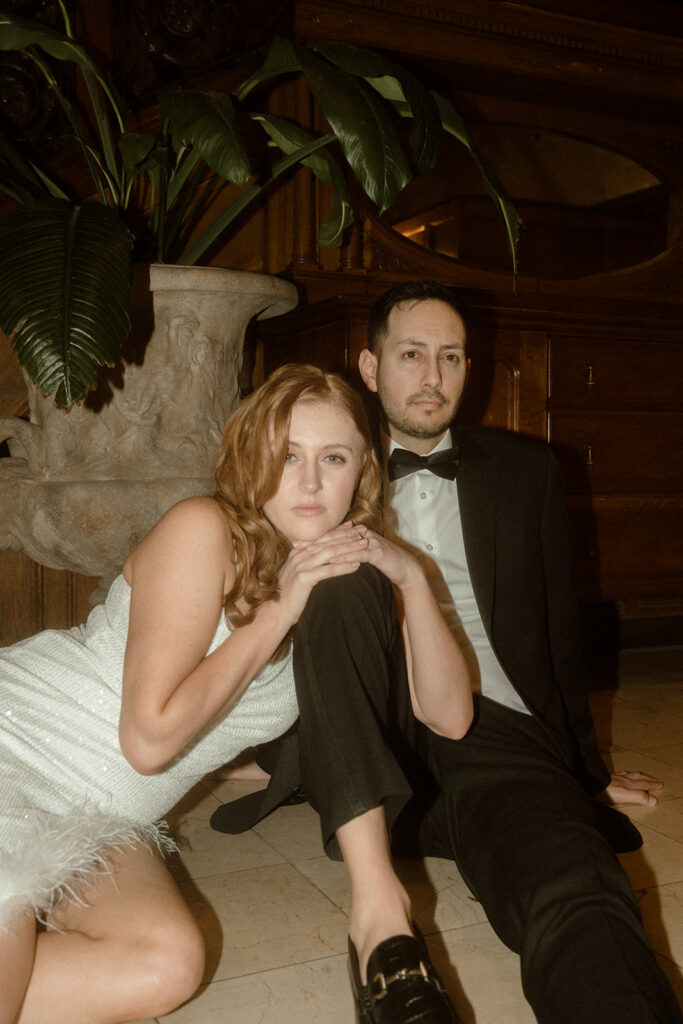 couple sitting together during their portland engagement photos at the benson hotel